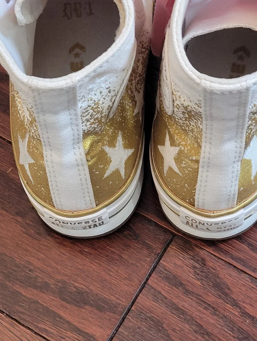 White High-Top Converse Chuck Taylor Sneakers with Pink Laces